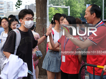 Candidates walk into the entrance examination center of the High School Affiliated to Beijing People's Congress for the National College Ent...