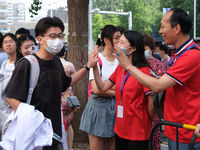 Candidates walk into the entrance examination center of the High School Affiliated to Beijing People's Congress for the National College Ent...