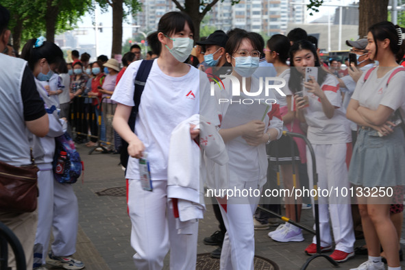 Candidates walk into the entrance examination center of the High School Affiliated to Beijing People's Congress for the National College Ent...