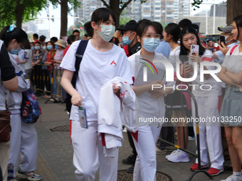 Candidates walk into the entrance examination center of the High School Affiliated to Beijing People's Congress for the National College Ent...