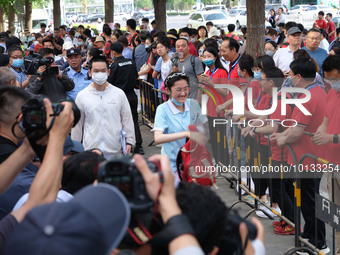 Candidates walk into the entrance examination center of the High School Affiliated to Beijing People's Congress for the National College Ent...