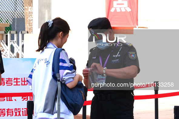 Candidates walk into the entrance examination center of the High School Affiliated to Beijing People's Congress for the National College Ent...