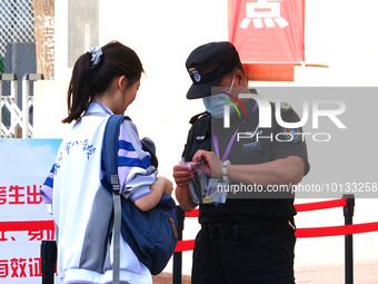 Candidates walk into the entrance examination center of the High School Affiliated to Beijing People's Congress for the National College Ent...