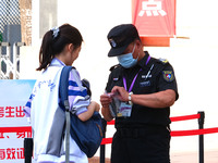 Candidates walk into the entrance examination center of the High School Affiliated to Beijing People's Congress for the National College Ent...