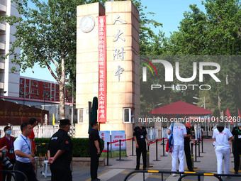 Candidates walk into the entrance examination center of the High School Affiliated to Beijing People's Congress for the National College Ent...