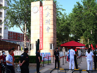 Candidates walk into the entrance examination center of the High School Affiliated to Beijing People's Congress for the National College Ent...