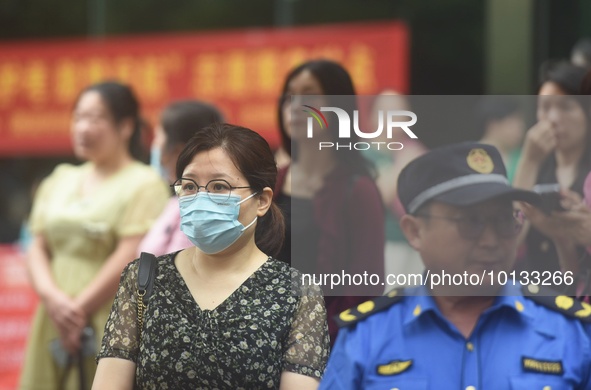 HANGZHOU, CHINA - JUNE 7, 2023 - Parents wait at the entrance of a national college entrance examination center in Hangzhou, Zhejiang provin...