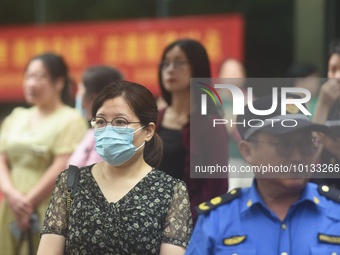 HANGZHOU, CHINA - JUNE 7, 2023 - Parents wait at the entrance of a national college entrance examination center in Hangzhou, Zhejiang provin...