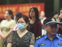 HANGZHOU, CHINA - JUNE 7, 2023 - Parents wait at the entrance of a national college entrance examination center in Hangzhou, Zhejiang provin...