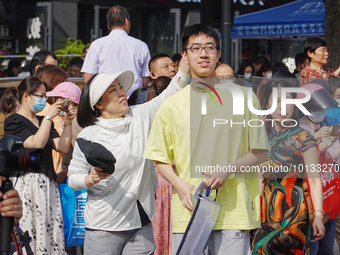 Candidates walk into a test room with admission tickets in Changzhou, Jiangsu province, China, on June 7, 2023. The 2023 National college en...