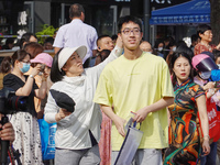 Candidates walk into a test room with admission tickets in Changzhou, Jiangsu province, China, on June 7, 2023. The 2023 National college en...