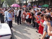 Candidates walk into a test room with admission tickets in Changzhou, Jiangsu province, China, on June 7, 2023. The 2023 National college en...