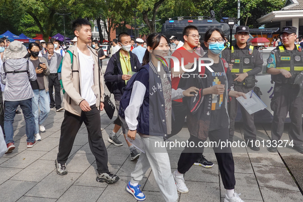 Candidates walk into a test room with admission tickets in Changzhou, Jiangsu province, China, on June 7, 2023. The 2023 National college en...