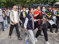 Candidates walk into a test room with admission tickets in Changzhou, Jiangsu province, China, on June 7, 2023. The 2023 National college en...