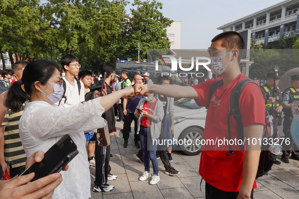 Candidates walk into a test room with admission tickets in Changzhou, Jiangsu province, China, on June 7, 2023. The 2023 National college en...