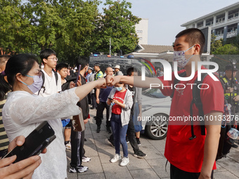 Candidates walk into a test room with admission tickets in Changzhou, Jiangsu province, China, on June 7, 2023. The 2023 National college en...