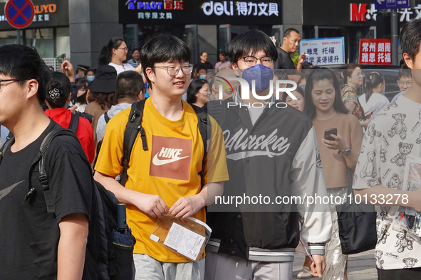 Candidates walk into a test room with admission tickets in Changzhou, Jiangsu province, China, on June 7, 2023. The 2023 National college en...