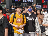 Candidates walk into a test room with admission tickets in Changzhou, Jiangsu province, China, on June 7, 2023. The 2023 National college en...