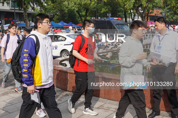 Candidates walk into a test room with admission tickets in Changzhou, Jiangsu province, China, on June 7, 2023. The 2023 National college en...