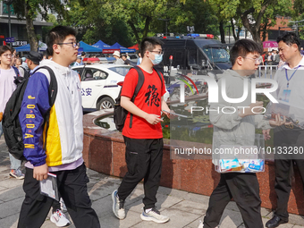 Candidates walk into a test room with admission tickets in Changzhou, Jiangsu province, China, on June 7, 2023. The 2023 National college en...