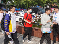 Candidates walk into a test room with admission tickets in Changzhou, Jiangsu province, China, on June 7, 2023. The 2023 National college en...