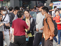 Candidates walk into a test room with admission tickets in Changzhou, Jiangsu province, China, on June 7, 2023. The 2023 National college en...