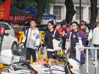 Candidates walk into a test room with admission tickets in Changzhou, Jiangsu province, China, on June 7, 2023. The 2023 National college en...