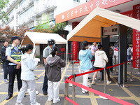  Candidates line up for the entrance exam at the No. 9 Middle School in Nanjing, East China's Jiangsu province, on June 7, 2023. The 2023 Na...