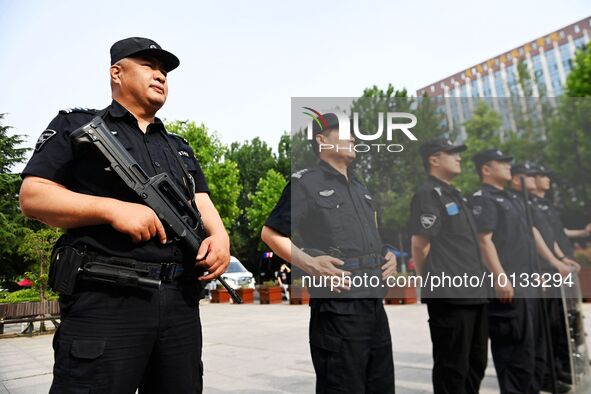 QINGDAO, CHINA - JUNE 7, 2023 - Armed police stand by in front of a college entrance exam site in Qingdao, Shandong province, China, June 7,...