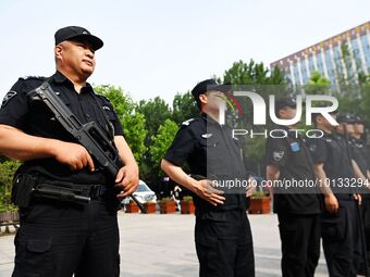 QINGDAO, CHINA - JUNE 7, 2023 - Armed police stand by in front of a college entrance exam site in Qingdao, Shandong province, China, June 7,...