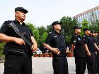 QINGDAO, CHINA - JUNE 7, 2023 - Armed police stand by in front of a college entrance exam site in Qingdao, Shandong province, China, June 7,...