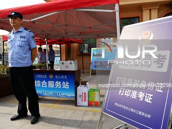 QINGDAO, CHINA - JUNE 7, 2023 - Traffic police direct traffic in front of a college entrance exam site in Qingdao, Shandong province, China,...