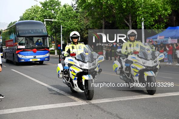 QINGDAO, CHINA - JUNE 7, 2023 - Traffic police direct traffic in front of a college entrance exam site in Qingdao, Shandong province, China,...