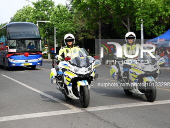 QINGDAO, CHINA - JUNE 7, 2023 - Traffic police direct traffic in front of a college entrance exam site in Qingdao, Shandong province, China,...