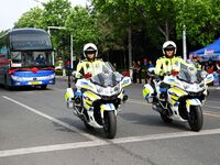 QINGDAO, CHINA - JUNE 7, 2023 - Traffic police direct traffic in front of a college entrance exam site in Qingdao, Shandong province, China,...