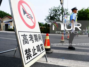 QINGDAO, CHINA - JUNE 7, 2023 - Traffic police direct traffic in front of a college entrance exam site in Qingdao, Shandong province, China,...