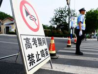 QINGDAO, CHINA - JUNE 7, 2023 - Traffic police direct traffic in front of a college entrance exam site in Qingdao, Shandong province, China,...