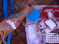 A Nepali blood donor donates blood in a blood donation campaign organized at Patan Durbar Square, a UNESCO World Heritage Site on the occasi...