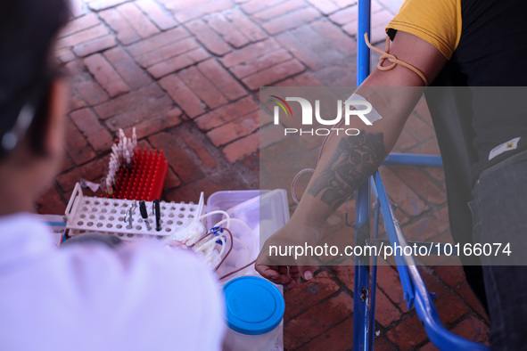 A Nepali blood donor donates blood in a blood donation campaign organized at Patan Durbar Square, a UNESCO World Heritage Site on the occasi...