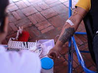 A Nepali blood donor donates blood in a blood donation campaign organized at Patan Durbar Square, a UNESCO World Heritage Site on the occasi...