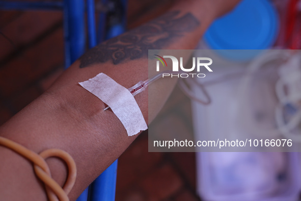 A Nepali blood donor donates blood in a blood donation campaign organized at Patan Durbar Square, a UNESCO World Heritage Site on the occasi...