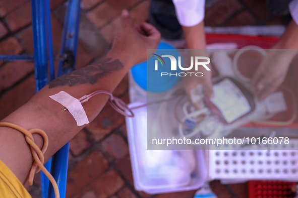 A Nepali blood donor donates blood in a blood donation campaign organized at Patan Durbar Square, a UNESCO World Heritage Site on the occasi...