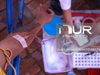 A Nepali blood donor donates blood in a blood donation campaign organized at Patan Durbar Square, a UNESCO World Heritage Site on the occasi...