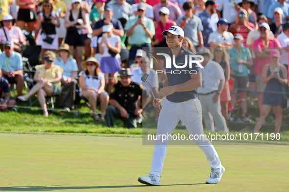 Viktor Hovland of Oslo, Norway walks on the 18th green during a playoff against Denny McCarthy of Jupiter, Florida during the final round of...