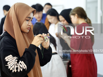 Foreign students make perfume sachets at the School of International Education at Nantong Vocational College of Science and Technology in Na...