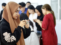 Foreign students make perfume sachets at the School of International Education at Nantong Vocational College of Science and Technology in Na...