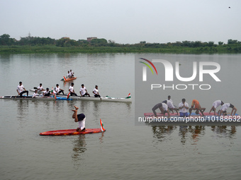 Participants perform yoga on the surface Yamuna River to mark the International Yoga Day celebrations on June 21, 2023 in New Delhi, India....