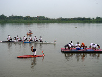 Participants perform yoga on the surface Yamuna River to mark the International Yoga Day celebrations on June 21, 2023 in New Delhi, India....