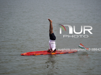 A participant performs yoga on the surface Yamuna River to mark the International Yoga Day celebrations on June 21, 2023 in New Delhi, India...