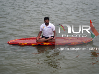 A participant performs yoga on the surface Yamuna River to mark the International Yoga Day celebrations on June 21, 2023 in New Delhi, India...